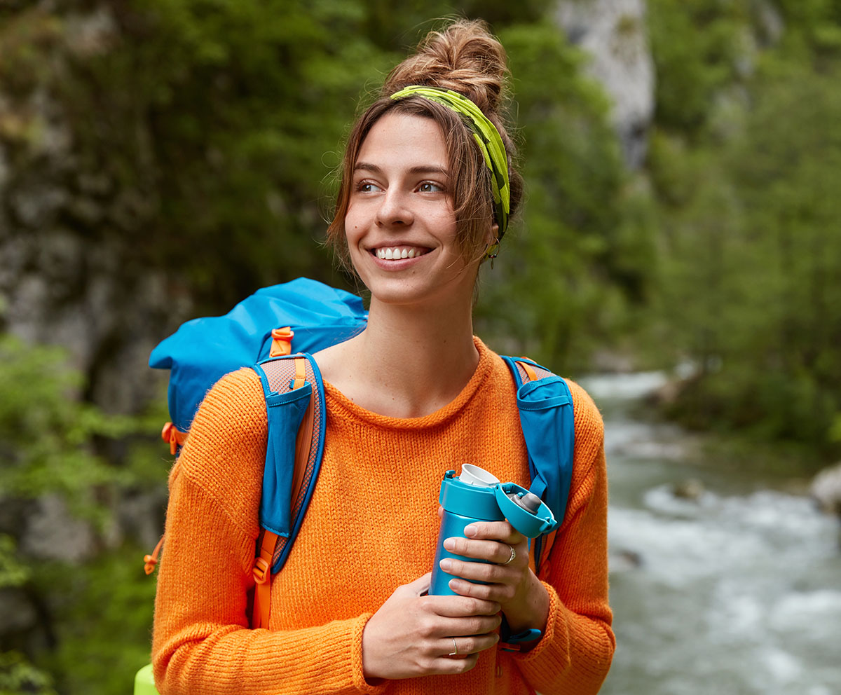 Happy women in nature after receiving TMS therapy for her OCD in Naperville IL