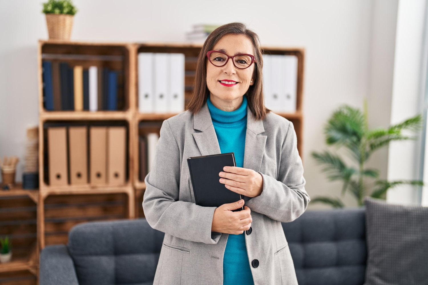 a photo of a woman psychiatrist at her office in front of a couch